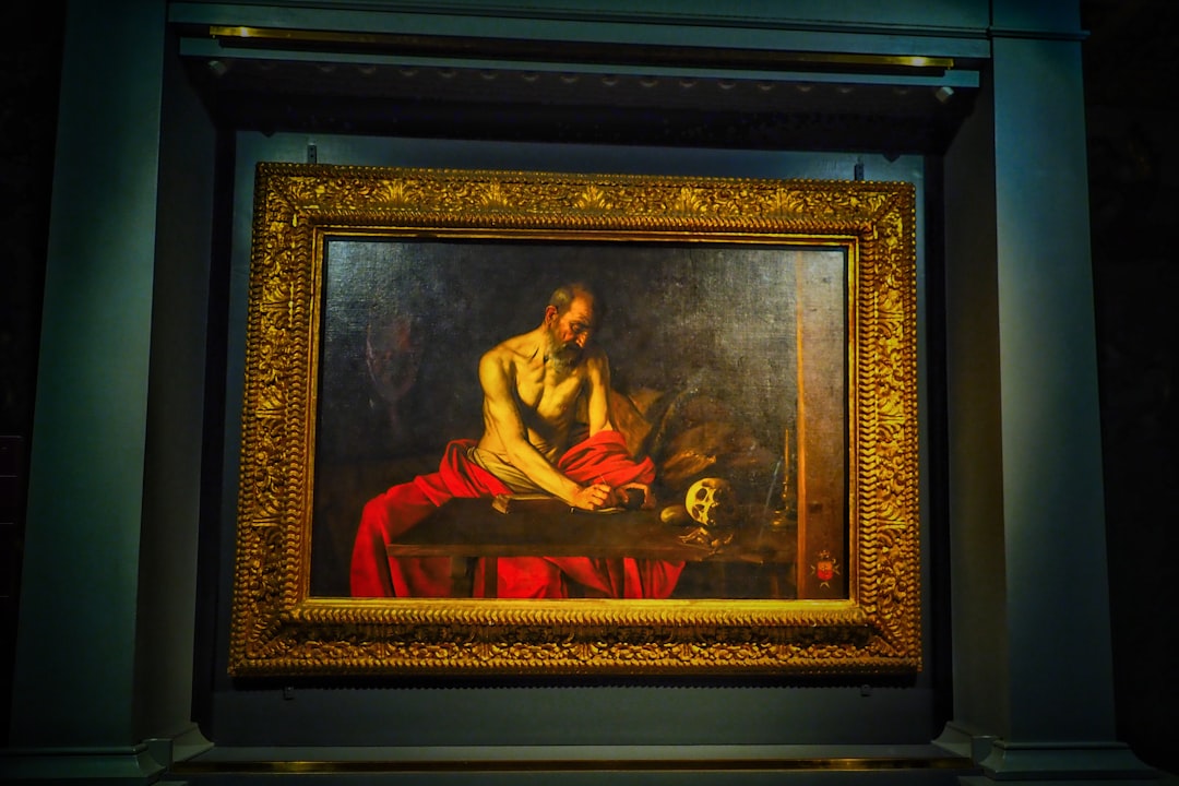 man in brown robe painting