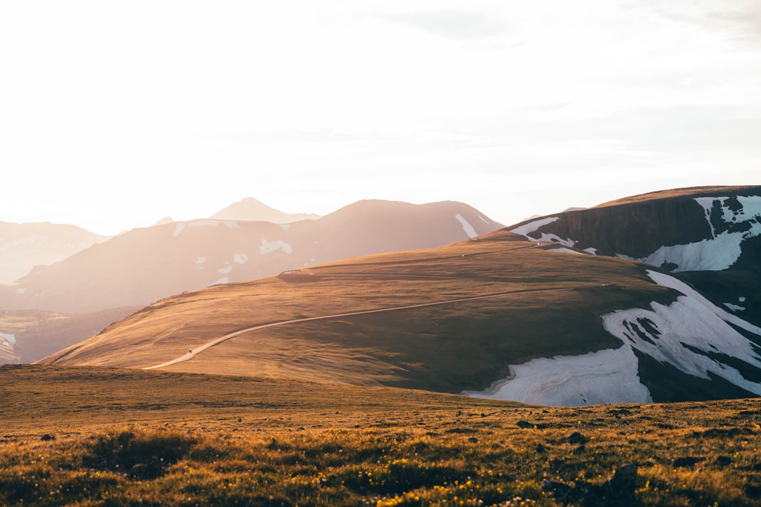 brown mountains near body of water during daytime