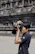 Photographer capturing candid moments amid grand palace architecture.