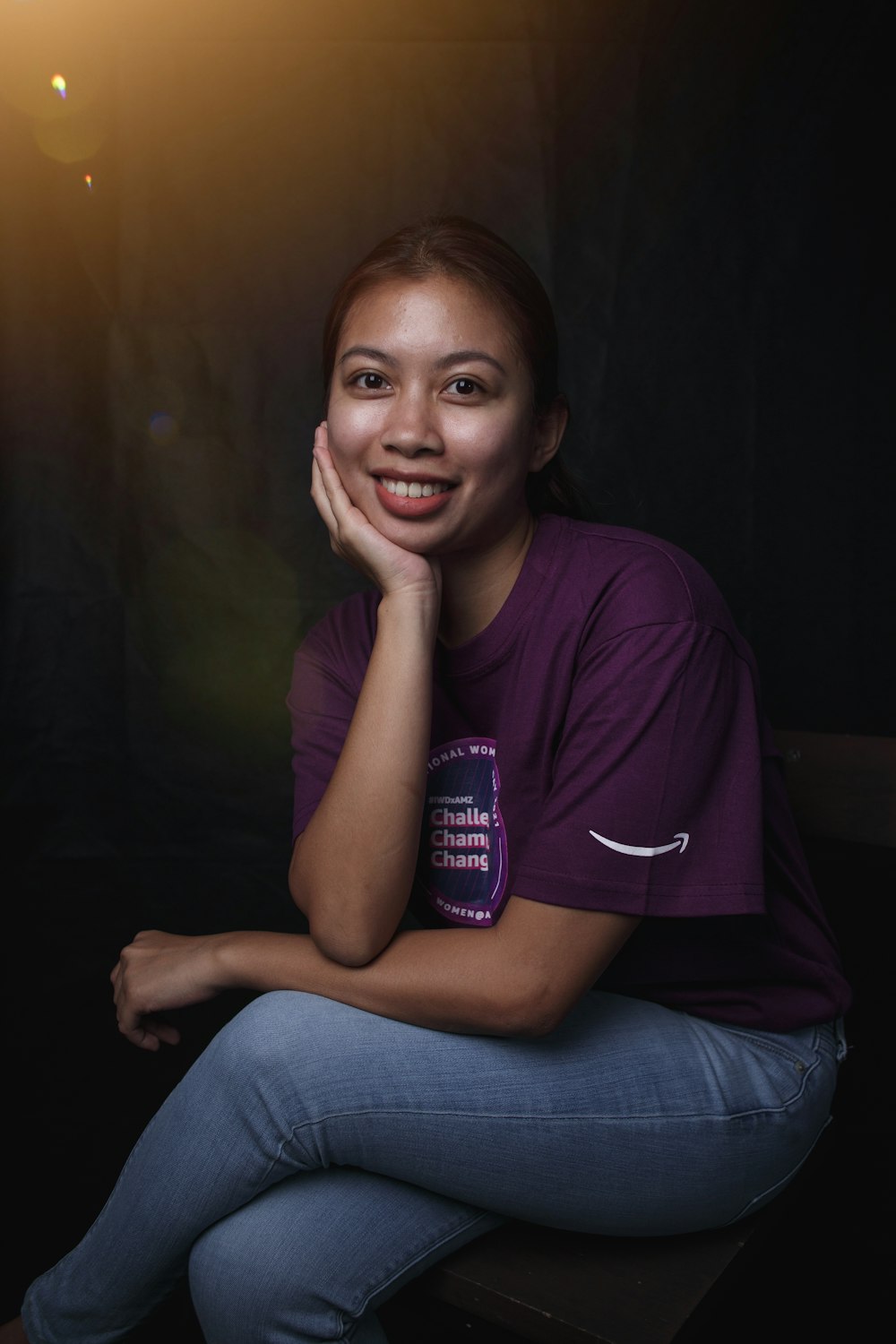 woman in purple crew neck t-shirt and blue denim jeans