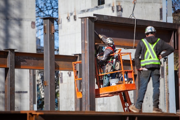 A construction worker inspecting a metal formwork system on-site.