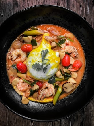 A beautifully presented Thai curry in a bowl with vibrant herbs and jasmine rice.