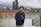 woman in black zip up jacket standing near red concrete building during daytime