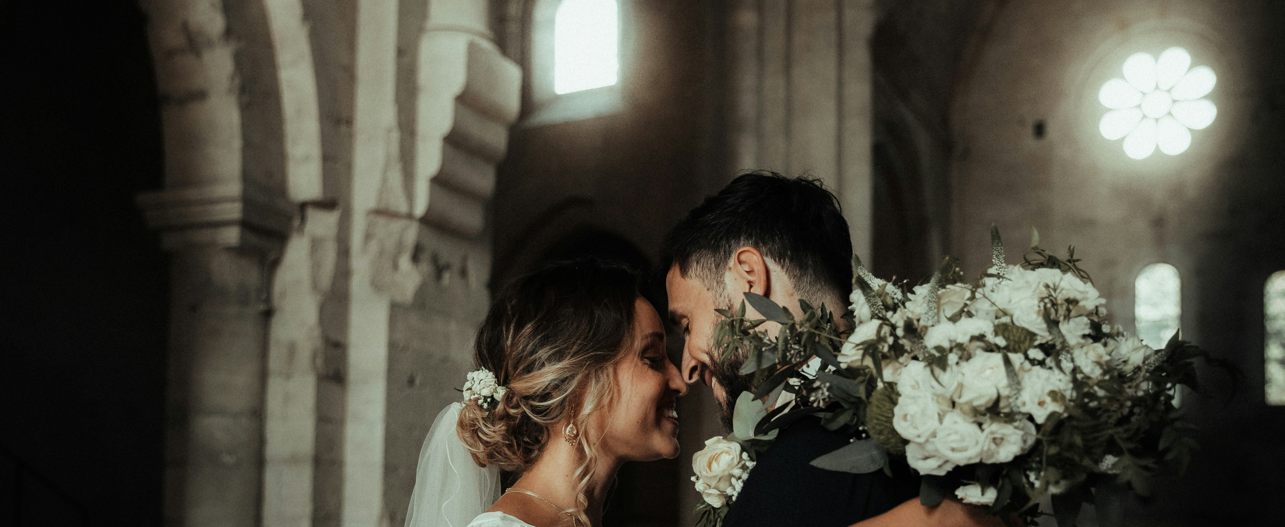 woman in white wedding dress kissing man in white dress shirt