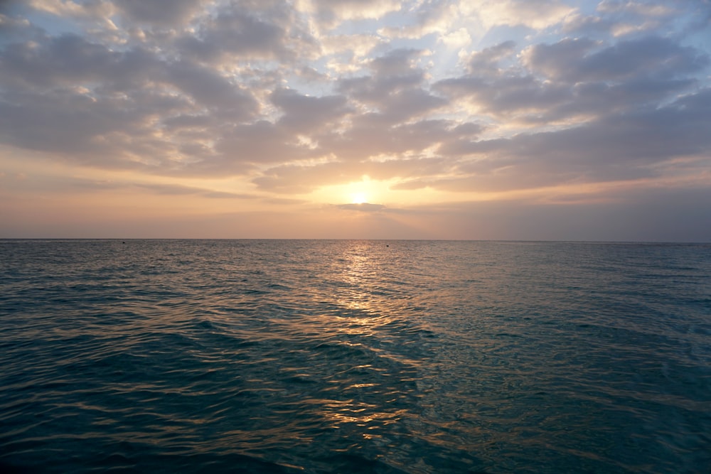 blue sea under white clouds during daytime