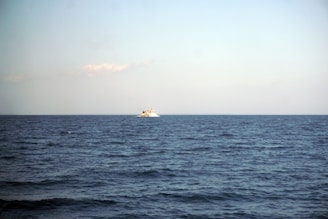 Oil vessel sailing steadily across a deep blue sea under a clear sky