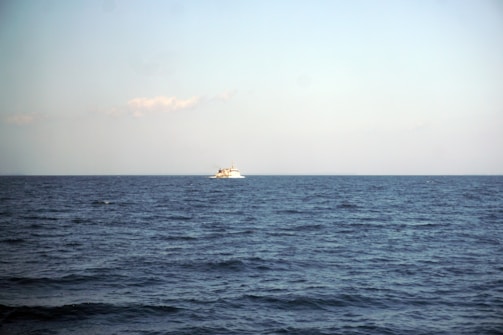 Oil vessel sailing steadily across a deep blue sea under a clear sky