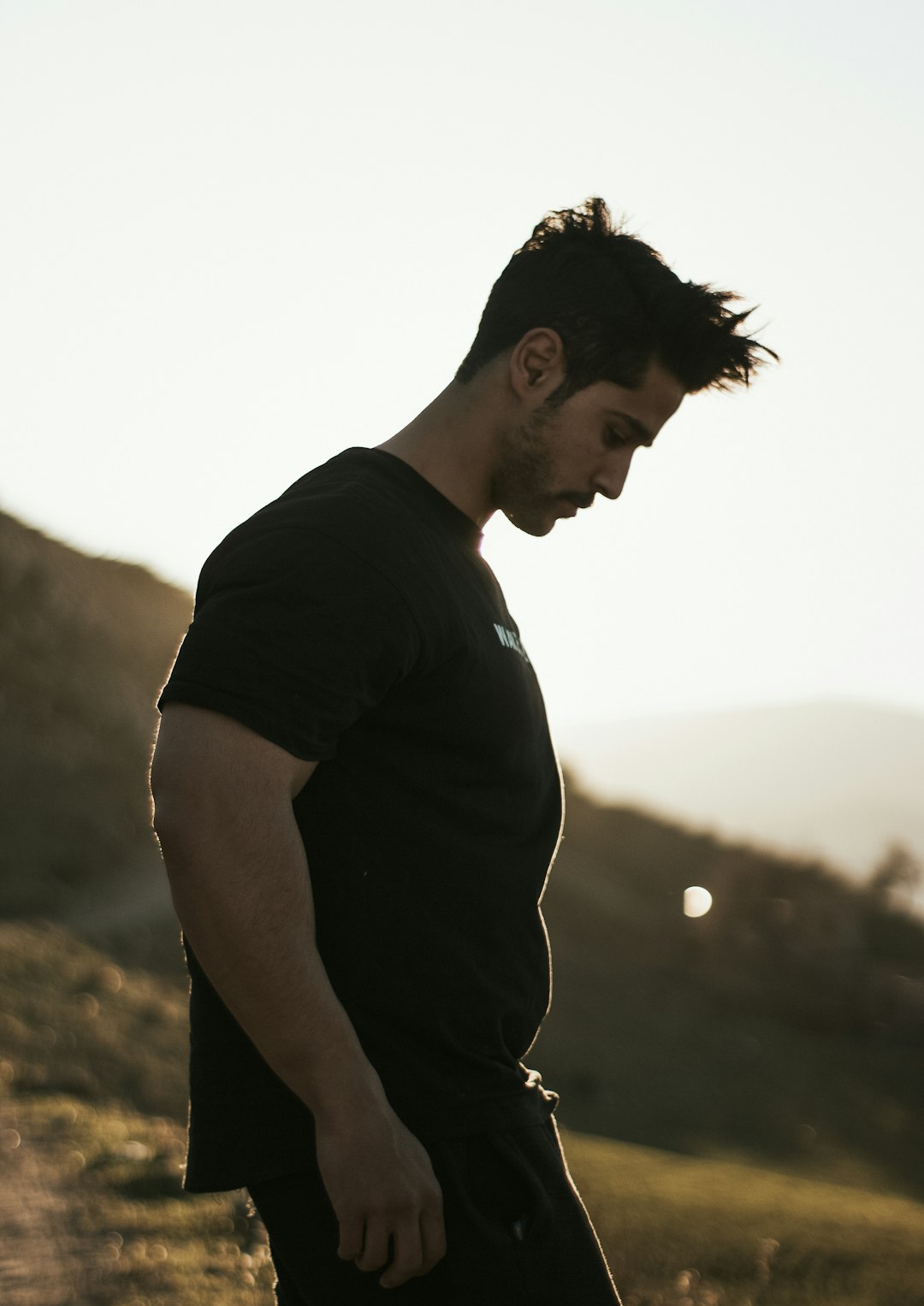 man in black crew neck t-shirt standing during daytime