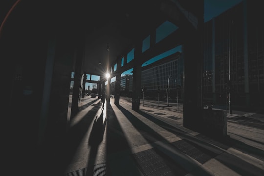 Dynamic street scene capturing the contrast of light and shadow on urban architecture.