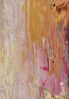 Hands layering textures on a painting, showing the tactile depth of their work.