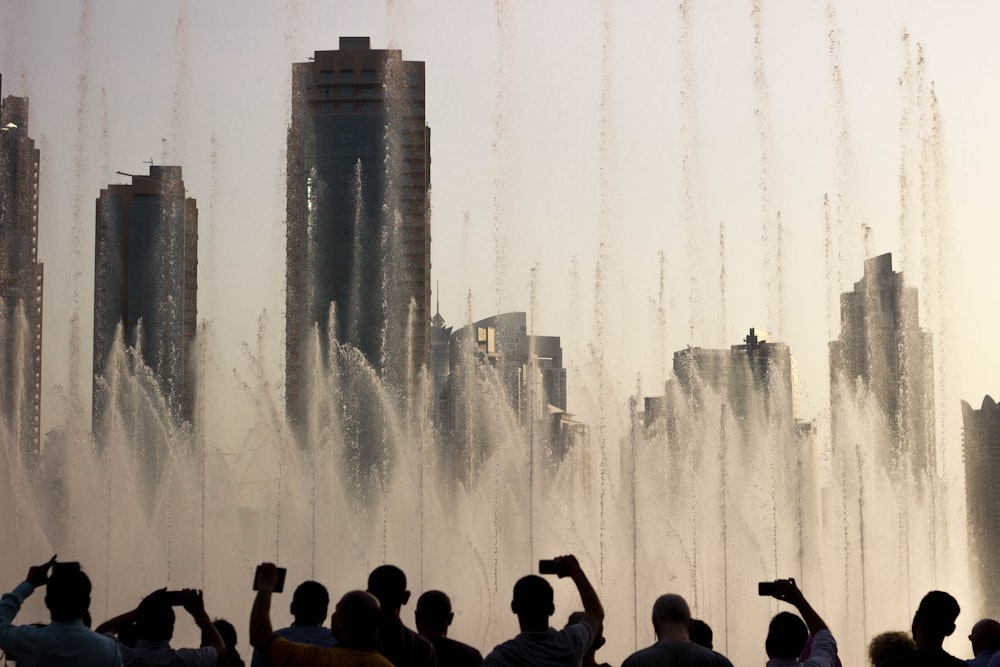 people sitting on the fountain during daytime