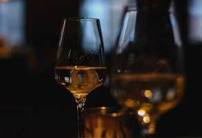 clear wine glass with brown liquid