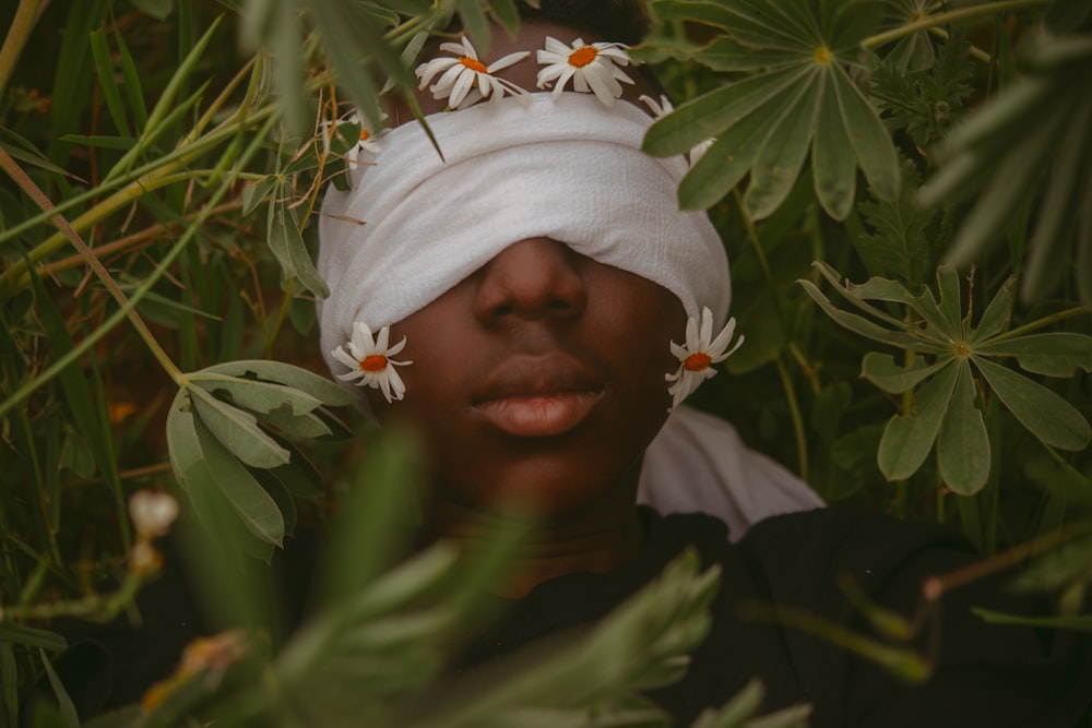 woman in white hijab near green leaves