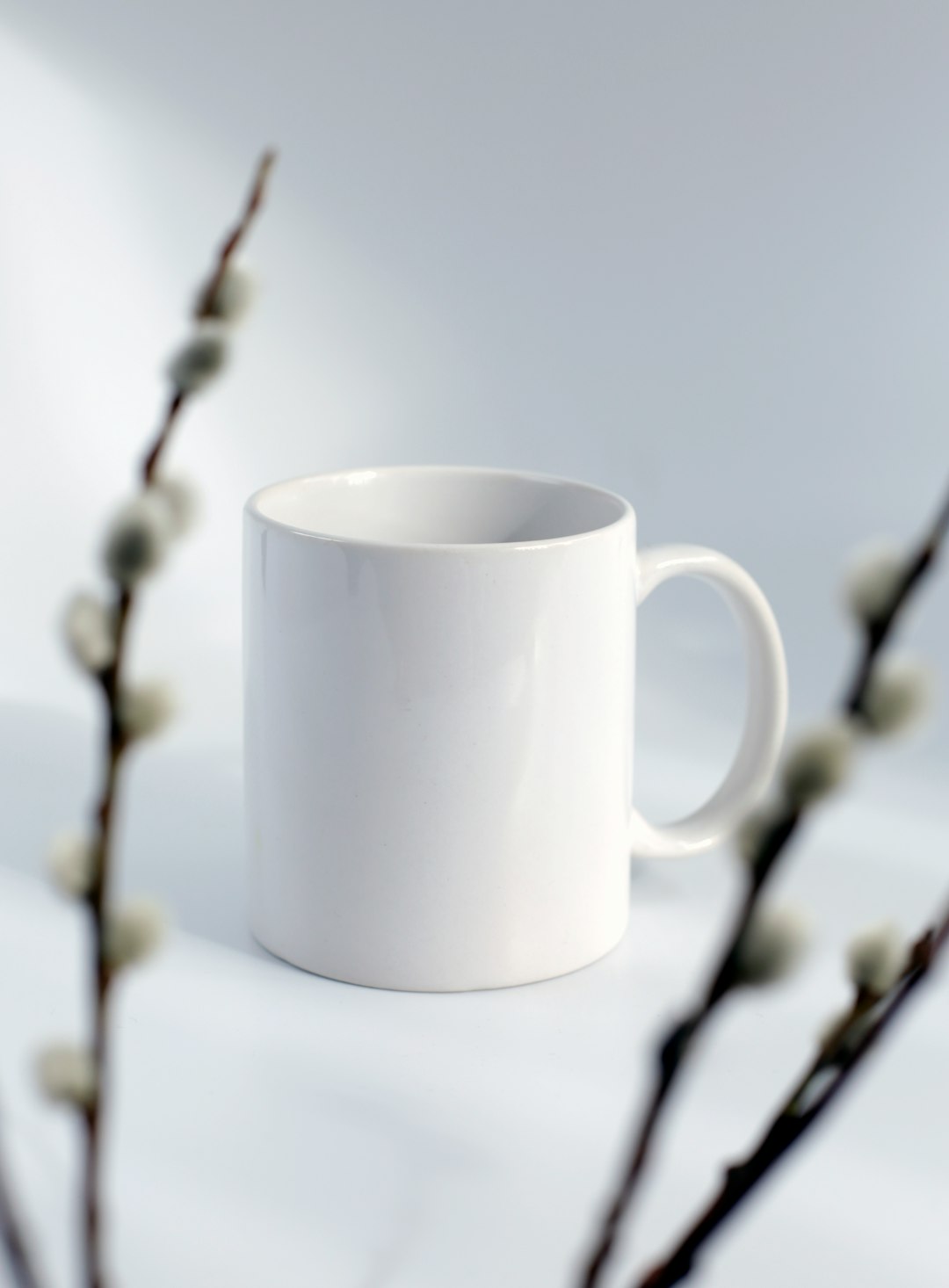  white ceramic mug on black metal wire fence cup