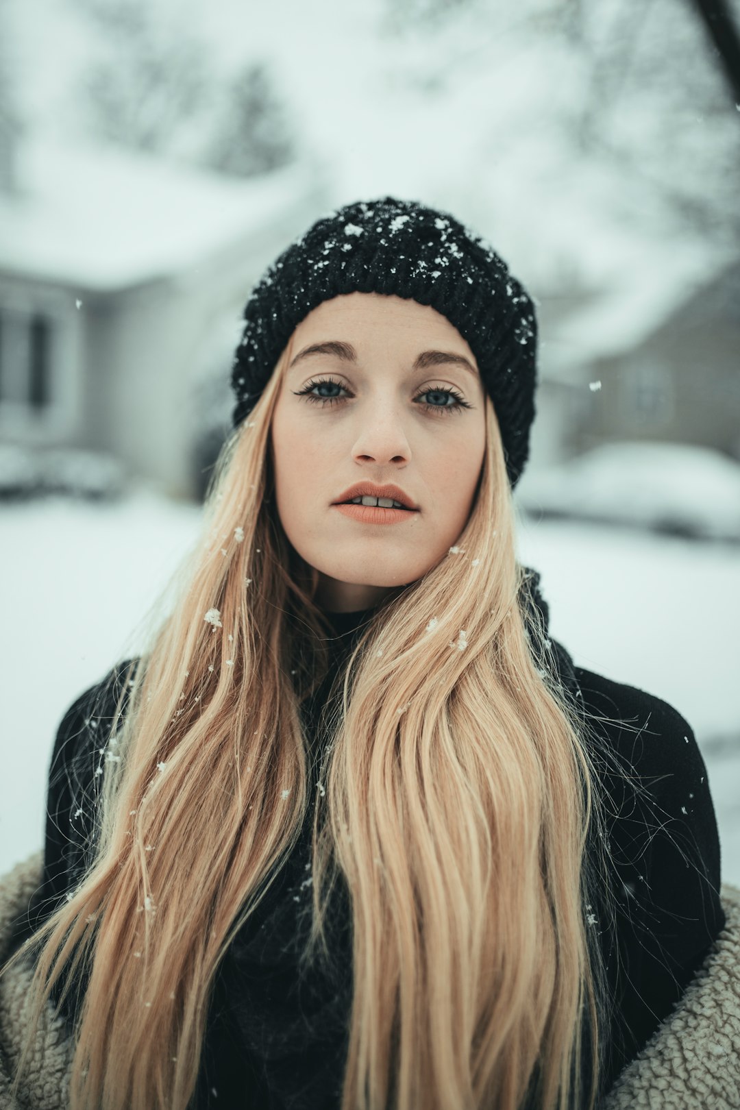 woman in black knit cap and black jacket