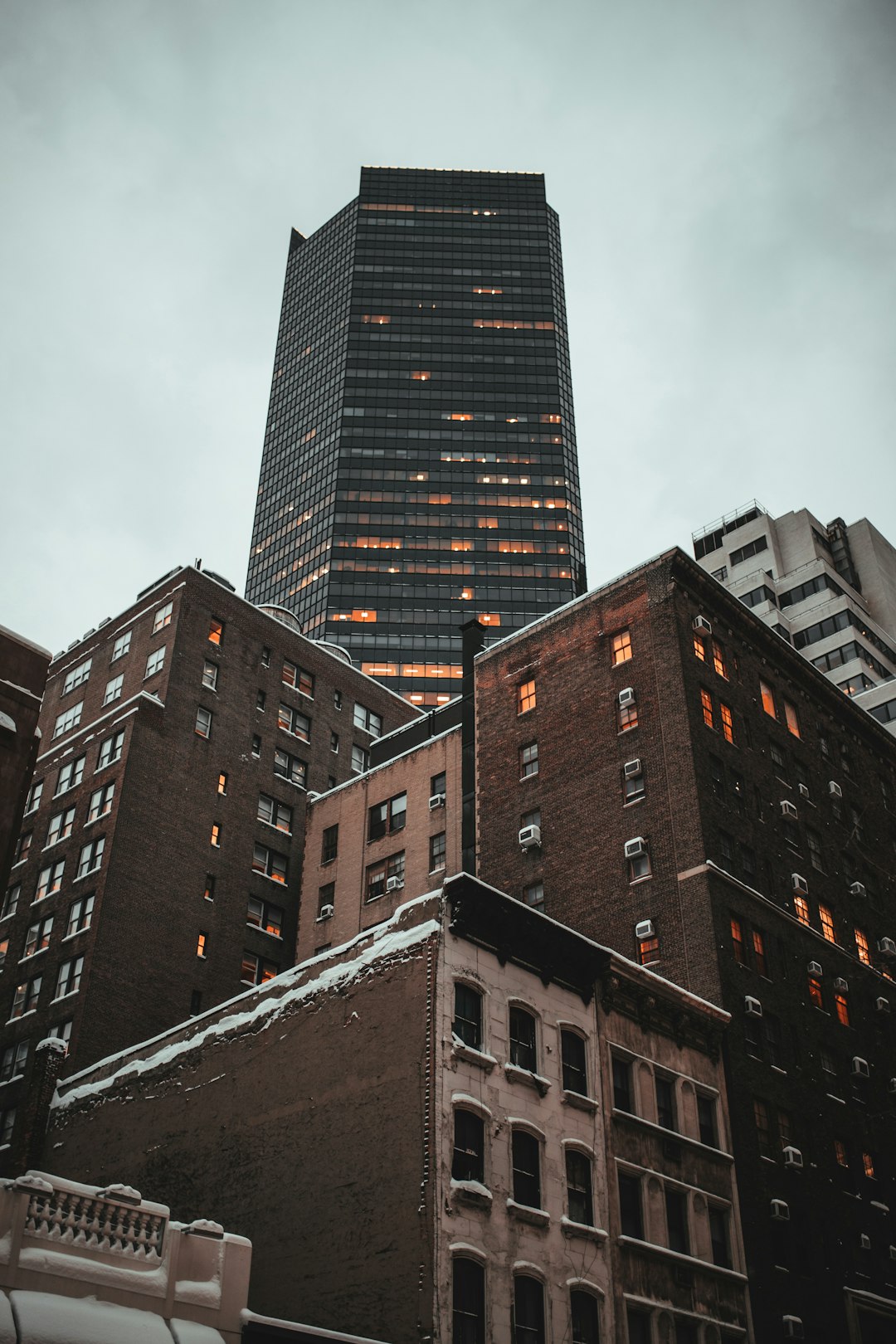 brown concrete building under white clouds during daytime