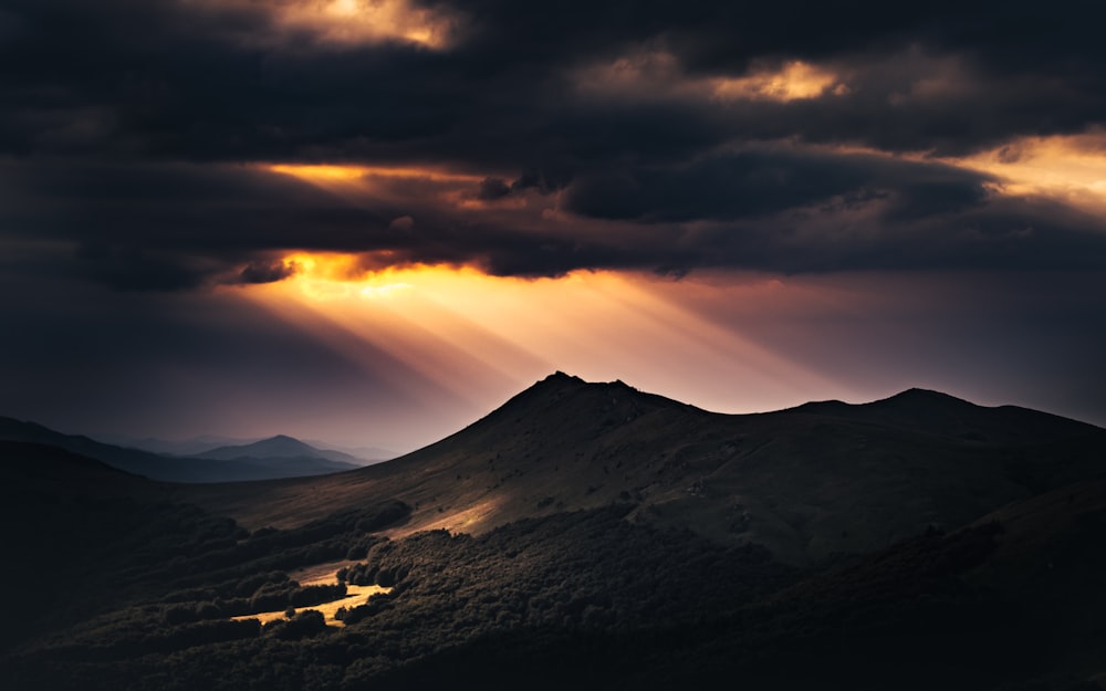 Montaña blanca y negra bajo cielo nublado durante la puesta del sol