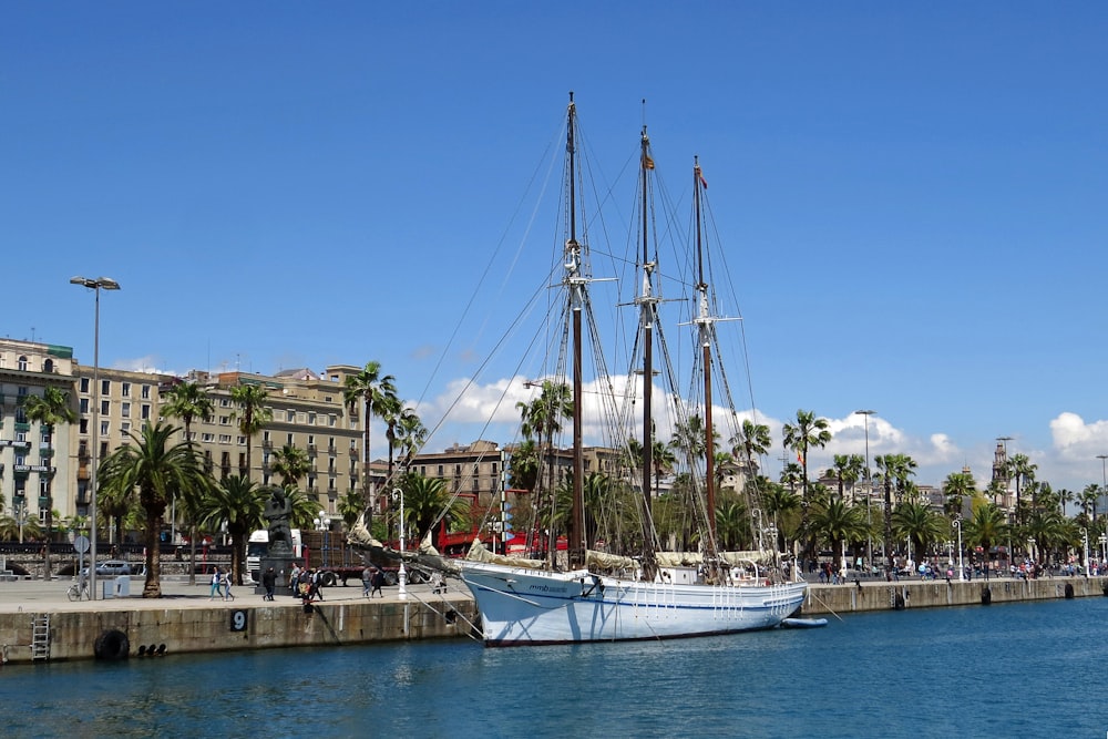 white boat on dock during daytime