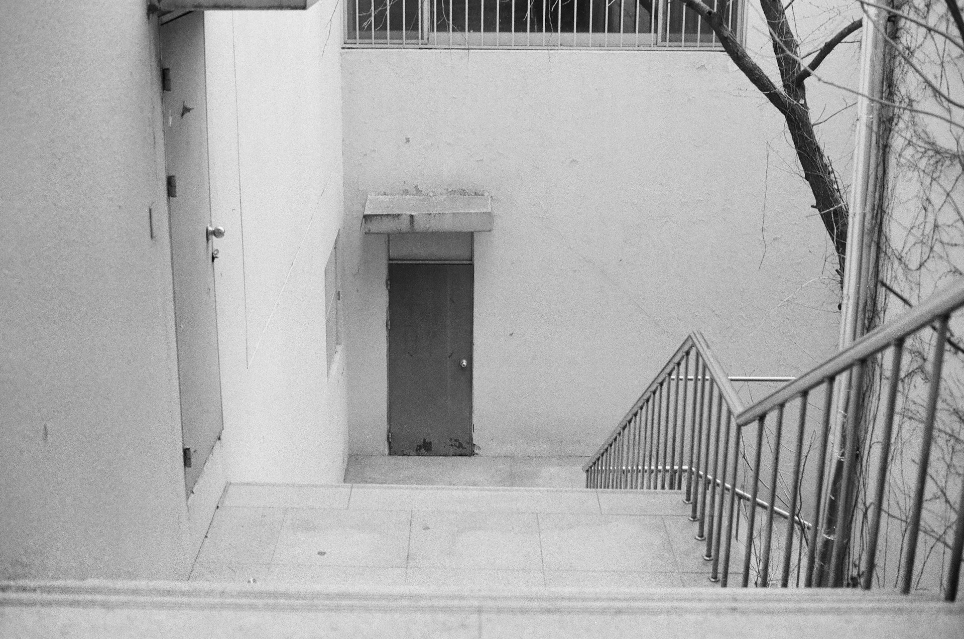 white concrete building with black metal gate
