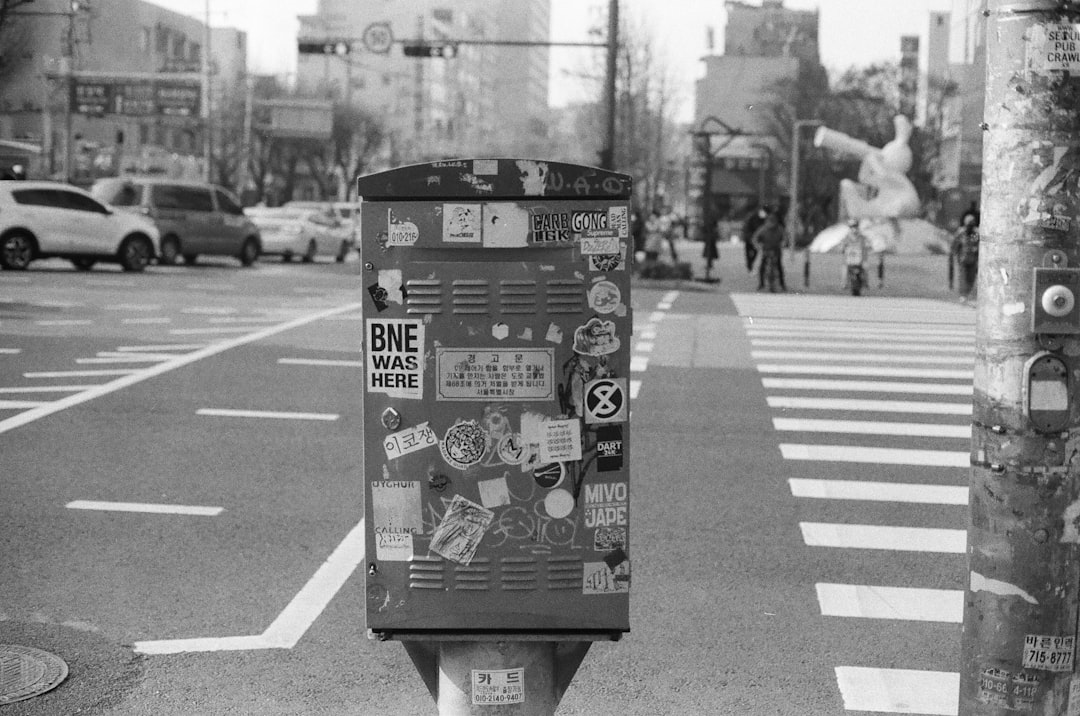 black and white trash bin on sidewalk