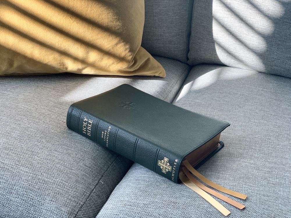 black book on gray couch