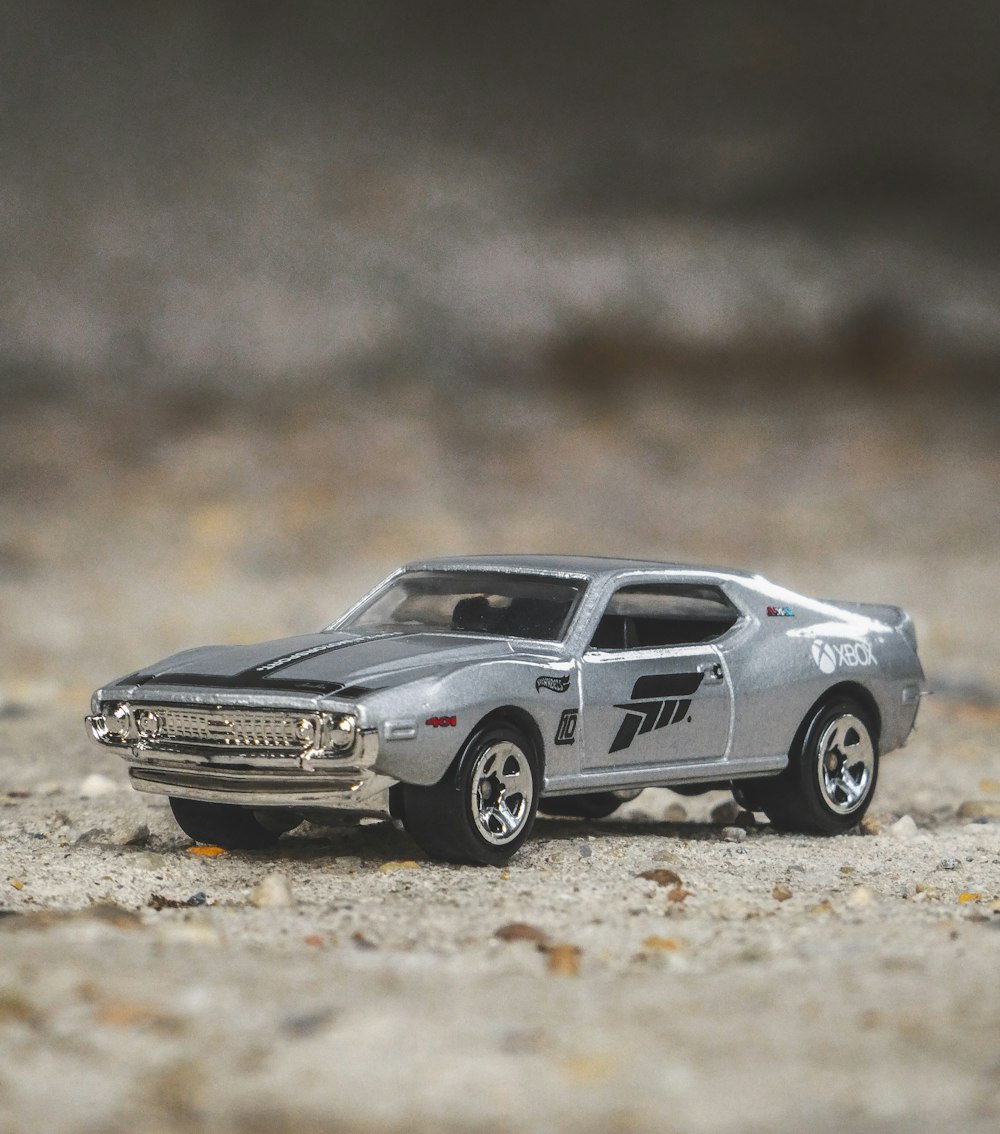 blue and white chevrolet camaro on brown soil