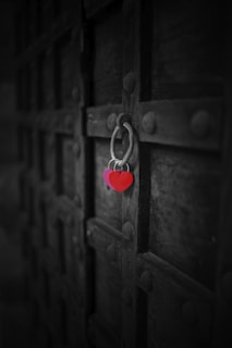 red heart padlock on brown wooden door