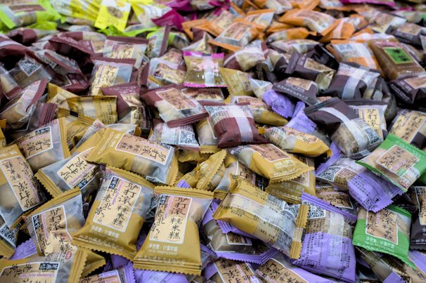 Close-up of colorful Chinese snack packages arranged artistically on a wooden table