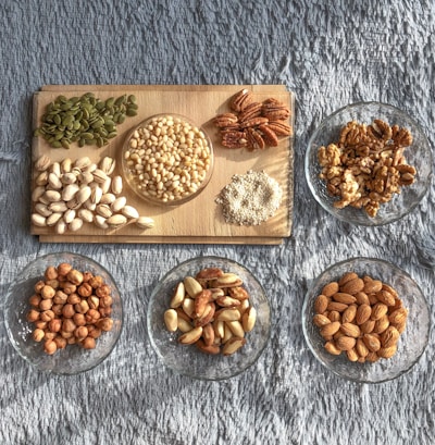 brown and white nuts on white ceramic bowls