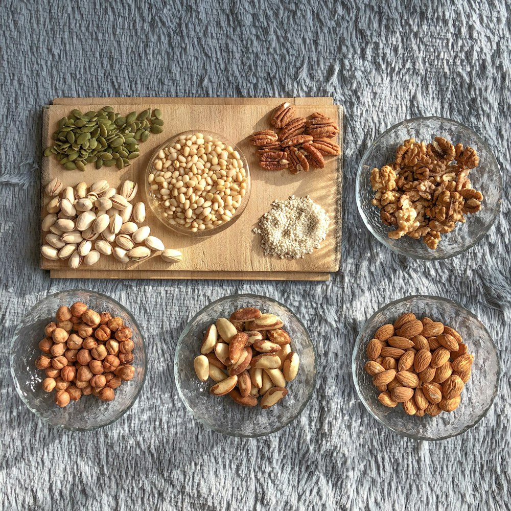 brown and white nuts on white ceramic bowls