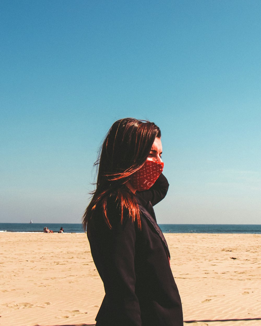 woman in black long sleeve shirt standing on beach during daytime