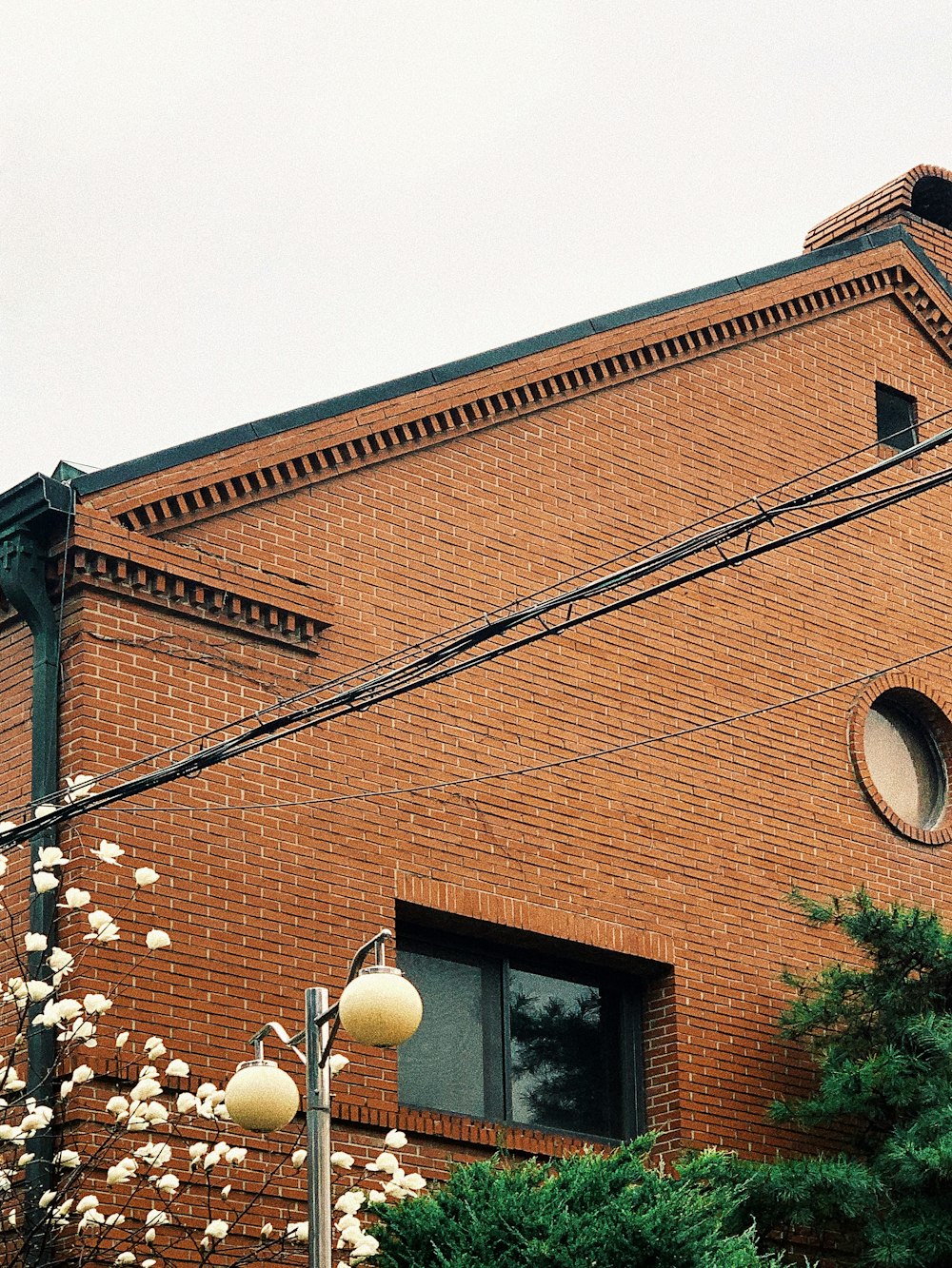 brown brick building with black metal fence