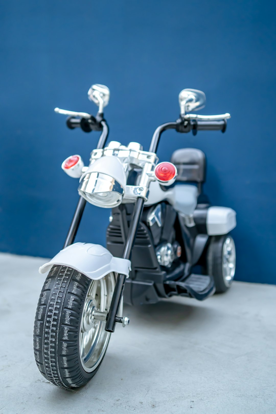 white and black motorcycle on gray concrete floor