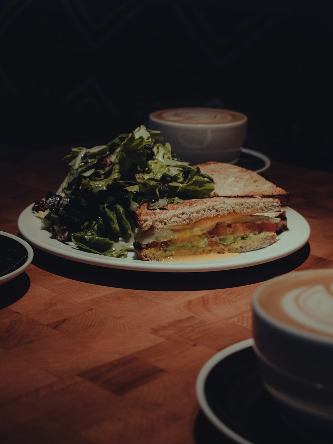 white ceramic plate with food on brown wooden table