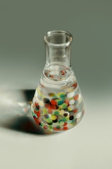 clear glass bottle with multicolored liquid