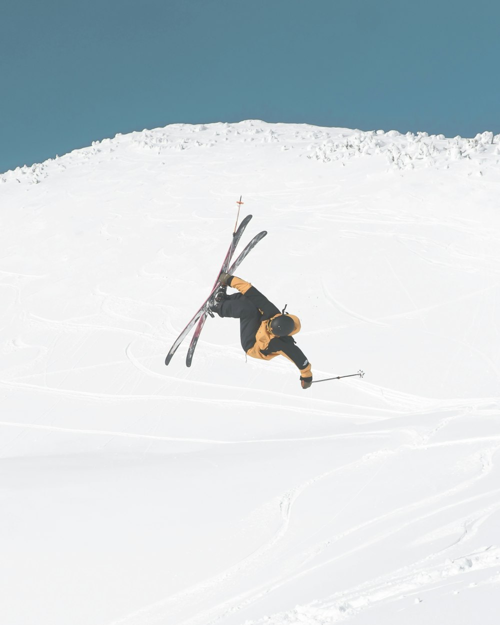 man in black jacket and brown pants doing snow ski during daytime