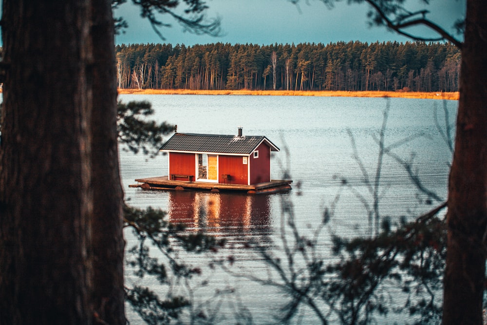brown wooden house on lake during daytime