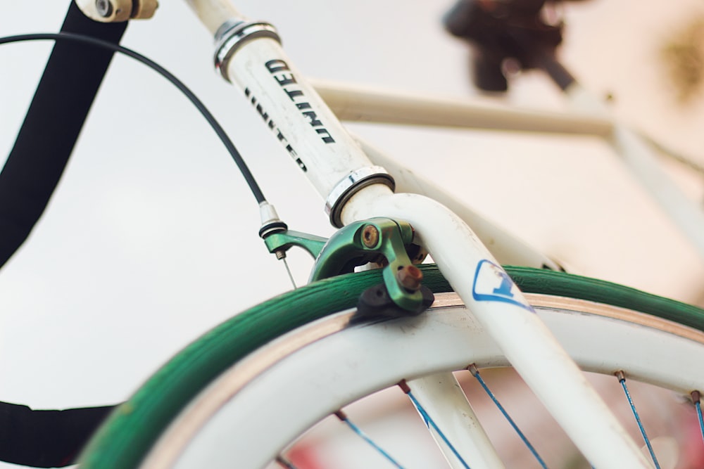 white and green bicycle with green handle bar