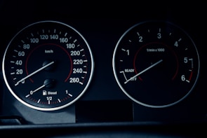 A close-up of a car dashboard displaying two circular gauges. The left gauge displays speed in km/h, ranging from 0 to 260, with a fuel indicator below marked for diesel. The right gauge shows engine revolutions per minute, ranging from 0 to 6, with 'READY' and 'OFF' indicators.