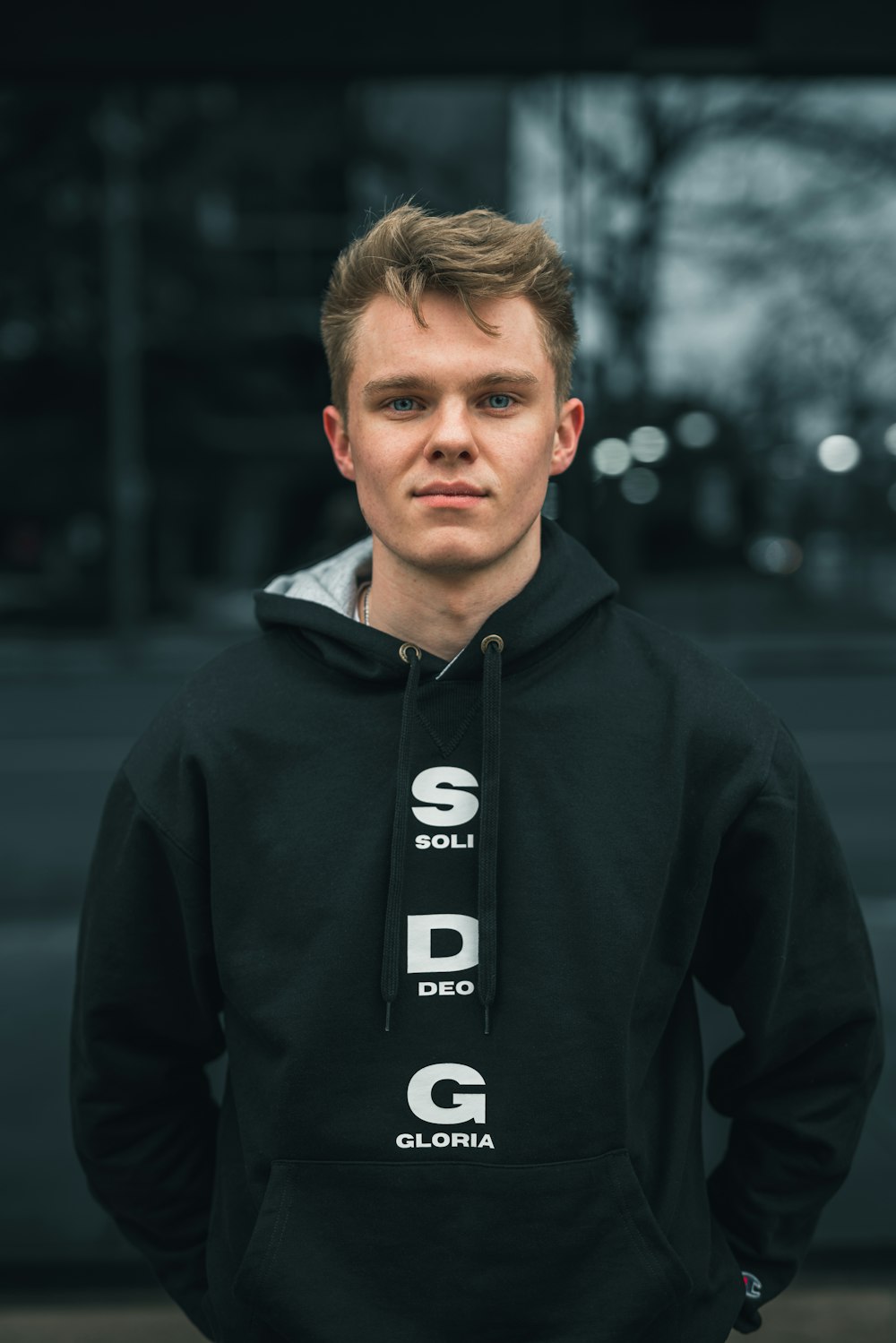 man in black hoodie standing during daytime