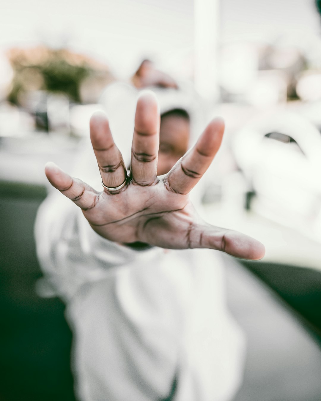 person wearing gold wedding band