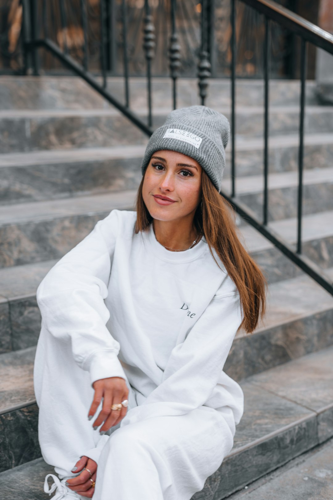 woman in white sweater and gray knit cap