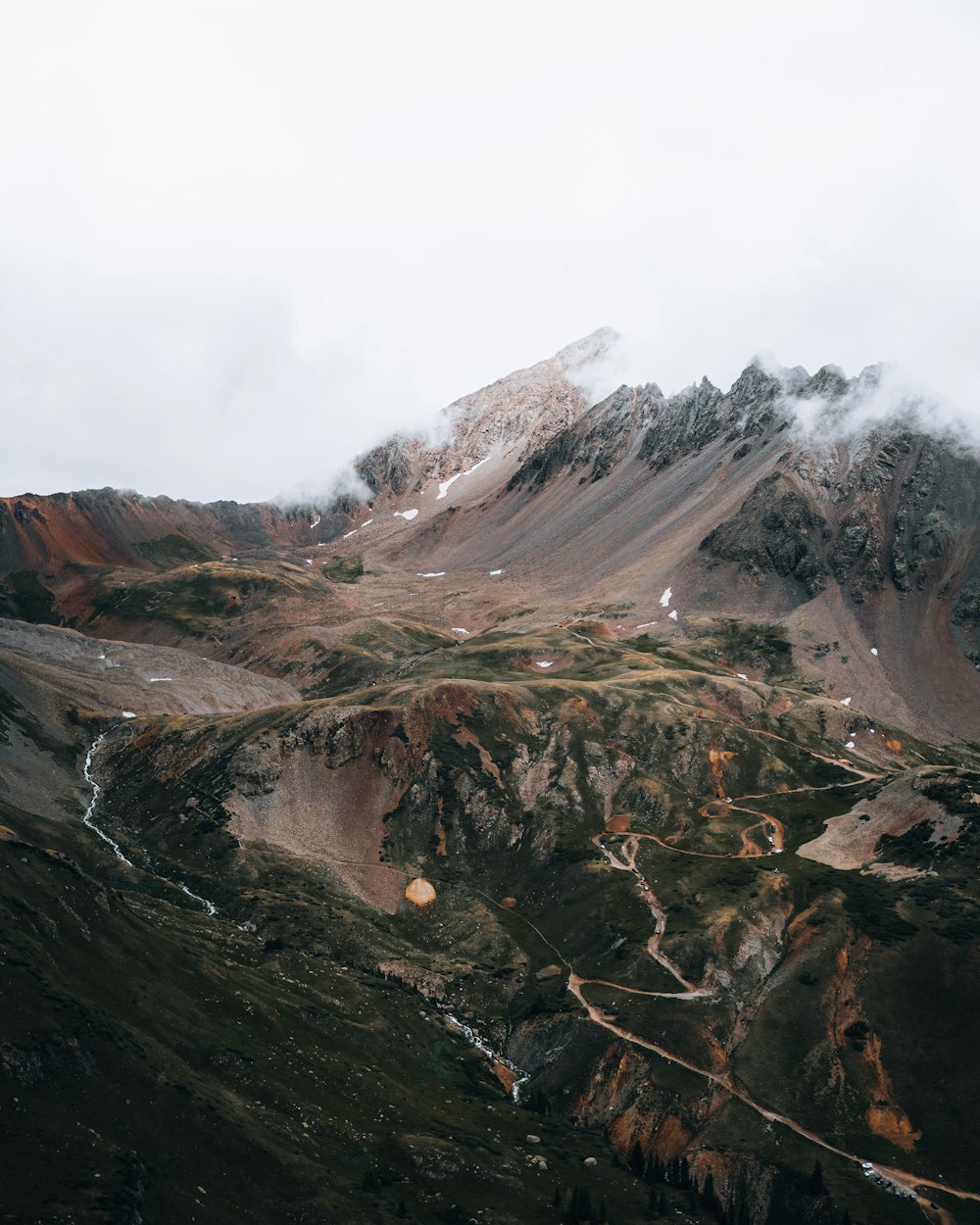 brown and gray rocky mountain under white cloudy sky during daytime