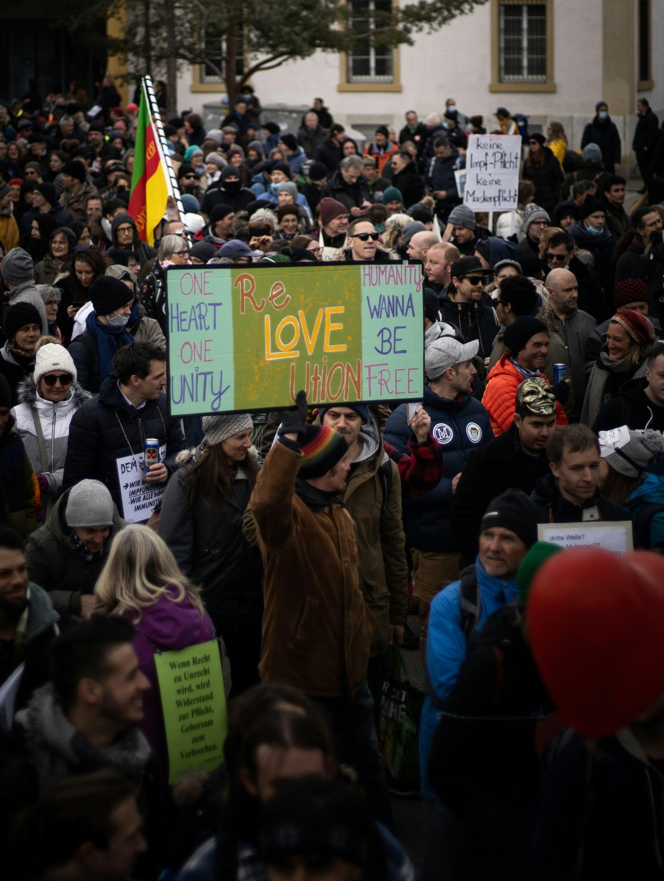 people holding green and white signage during daytime