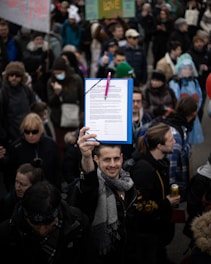 A group of community members holding a petition clipboard near Ponto Beach.