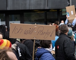 people standing and holding brown wooden board during daytime