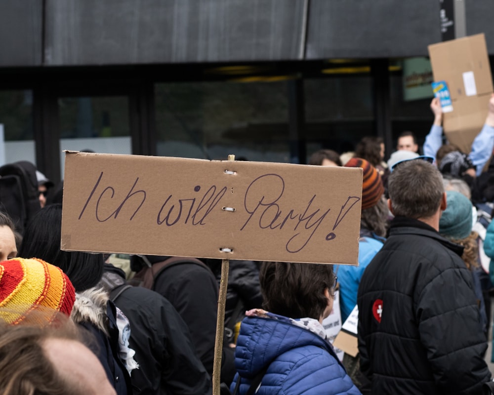 people standing and holding brown wooden board during daytime