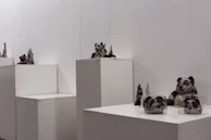 A collection of family sculptures displayed against a minimalist backdrop, emphasizing their handcrafted detail.