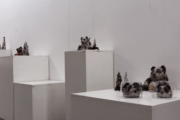 Abstract sculptures made from recycled materials showcased in a bright gallery space.