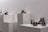 Close-up of diverse textured sculptures displayed in a minimalist gallery setting.